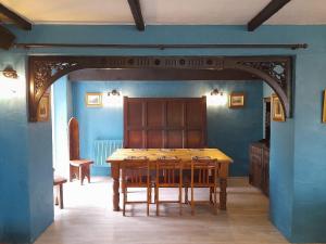 a dining room with a wooden table and chairs at The Cottage Inn in Llandeilo