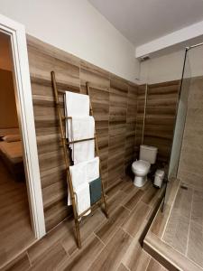 a bathroom with a towel rack and a toilet at LMJ APARTMENTS in Artemida +19 photos