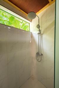 a shower stall in a bathroom with a window at Vacanza Mathiveri in Mathiveri