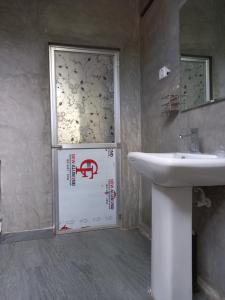 a bathroom with a white door and a sink at Indra Sisila Resort and Villa Bentota in Bentota +43 photos