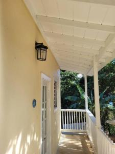 a porch of a white house with a light on it at The Northside Cottage in Nazareth