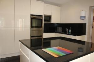 a kitchen with a counter with a rainbow plate on it at Lamorna in Olney
