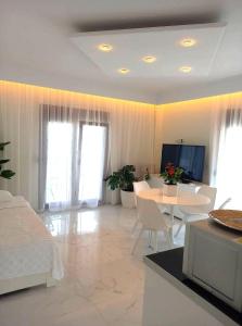 a living room with a bed and a table at Lux Suite Sea Front Avra in Pefkohori