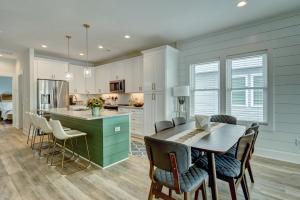 a kitchen and dining room with a table and chairs at Oasis at the Beach in Carolina Beach