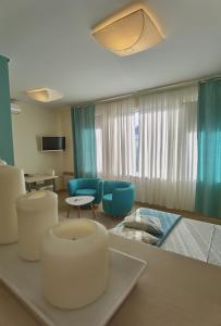 a living room with a table and chairs in a room at Cuvi Studio S in Rovinj