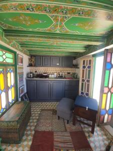 a room with a kitchen with a ceiling with stained glass at The Jewel of the Northern Moroccan Atlantic in Asilah in Asilah
