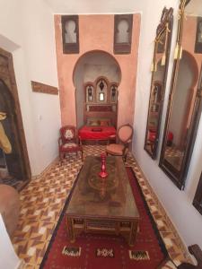 a bedroom with a bed and a table in a room at The Jewel of the Northern Moroccan Atlantic in Asilah in Asilah