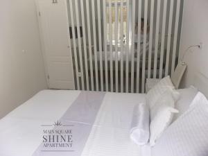 a bed with white sheets and pillows in a room at Luxurios and historic apartment "Shine" - right on the Main Square in Zagreb +76 photos