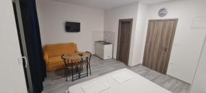 a living room with a couch and a table and chairs at Apartments Dado in Baška Voda