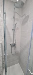 a shower in a bathroom with a glass door at Apartments Dado in Baška Voda +20 photos