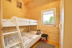a bedroom with bunk beds in a log cabin at Domki Pod Sudeckim Niebem in Duszniki Zdrój