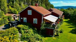 ein rotes Haus mit einem LKW davor, in der Unterkunft Kullerbacka Gästhus in Segersta