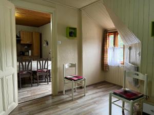 a room with two chairs and a dining room at Palma Apartment 2 in Schottwien