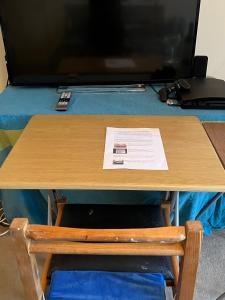 una mesa de madera con TV encima de una mesa en Room with A View en Londres