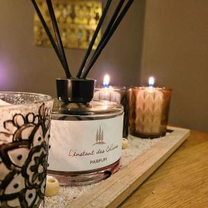 three candles are sitting on a table with candles at Hôtel Restaurant Le Lachens in La Bastide