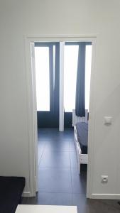 a bedroom with a bed and a door with a mirror at * Moulin Rouge Getaway * 1BR + Desk + Gym weights in Paris