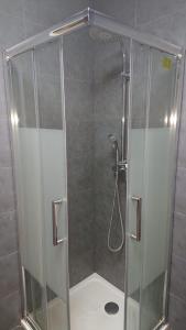 a shower with a glass door in a bathroom at * Moulin Rouge Getaway * 1BR + Desk + Gym weights in Paris