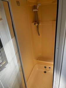 a shower with a glass door in a bathroom at Central Ingoldmells, Seaview 6 berth in Ingoldmells