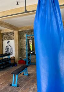 a blue gym with a bench and a mirror at Blue Reef Sport & Fishing Lodge and Bungalows in Jambiani