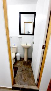 a bathroom with a sink and a toilet and a mirror at Departamento en Pacasmayo in Pacasmayo