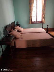 a bed in a bedroom with a window at Le Manoir in Antananarivo