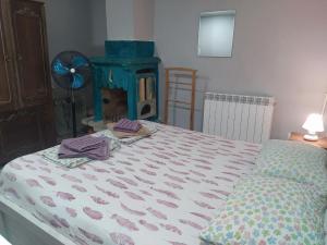 a bedroom with a bed and a fan at Guesthouse Kato in Tbilisi City