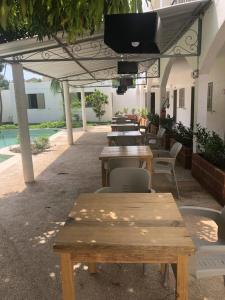 a row of tables and chairs with a tv on top at le HBR de Saly in Saly Portudal