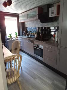 a kitchen with stainless steel appliances and a table at Casa Livia in Lieser