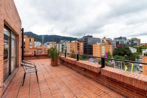 a balcony with a bench on top of a building at Hotel Madisson Inn Luxury By GEH Suites in Bogotá