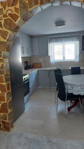 a kitchen with a table and chairs and a brick wall at Plaza House in Kanakia