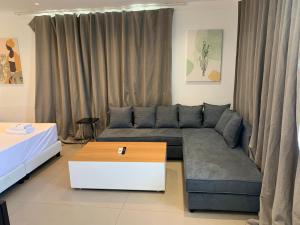 a living room with a couch and a coffee table at Majestic Mykonos in Ornos