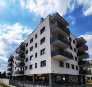 a white building with balconies on the side of it at Apartment MRVICA near the Zagreb Airport in Velika Gorica