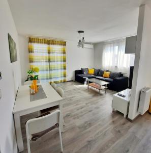 a living room with a couch and a table at Apartment MRVICA near the Zagreb Airport in Velika Gorica