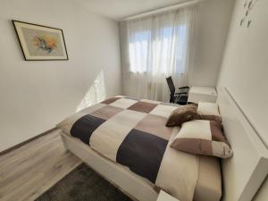 a bedroom with a bed and a desk and a window at Apartment MRVICA near the Zagreb Airport in Velika Gorica
