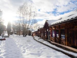a snow covered sidewalk next to a building at Auberge de Jeunesse HI Chamonix in Chamonix-Mont-Blanc