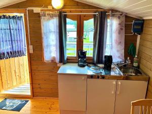 a kitchen with a counter and a sink in a cabin at Aspnes Camping AS in Mosjøen