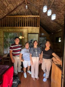 a group of people posing for a picture in a room at Bahay Kubo ZaiLaiH in Silang