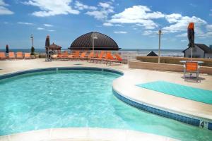 a swimming pool with a view of the ocean at Boardwalk Resorts at Atlantic Palace in Atlantic City