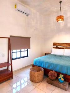 Säng eller sängar i ett rum på Casa Mayab Bacalar