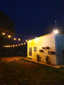 a white building with lights on it at night at Casa Mayab Bacalar in Bacalar