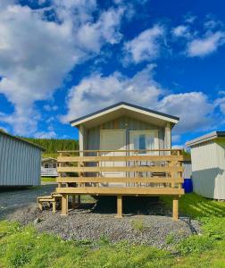 un banco de madera frente a un edificio en Aspnes Camping AS, en Mosjøen