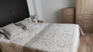 a bedroom with a bed with a white bedspread at La Loma de Torrevieja in Torrevieja