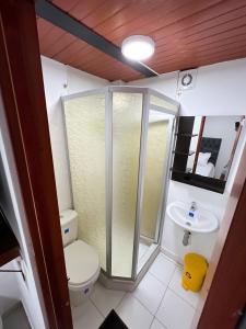 ein Bad mit einer Dusche, einem WC und einem Waschbecken in der Unterkunft Hostal Casa del Café in Bogotá