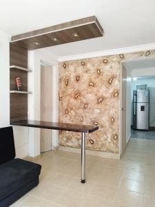 a ping pong table in a room with a wall at Apartamento Quintas de San Javier in Medellín