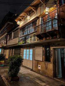 a building with a balcony on the side of it at Hostal Casa del Café in Bogotá