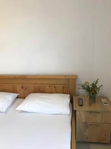 a bedroom with a bed and a night stand with a plant at Vila Bedro in Sarandë