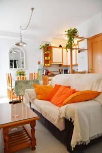 a bedroom with a bed with orange pillows on it at Casa Lea in Islantilla