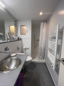 a bathroom with a sink and a toilet and a shower at ROSAS Vue sur Mer in Roses +19 photos