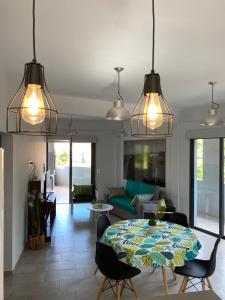 a living room with a table and several lights at Bajada Vieja Departamentos in Posadas