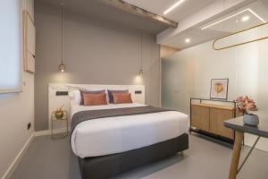 a bedroom with a large bed and a desk at Bilbao Centric Apartments in Bilbao